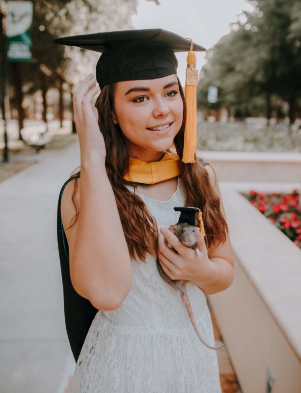 Woman celebrates graduation with her pet rat who helped her pass her master's program